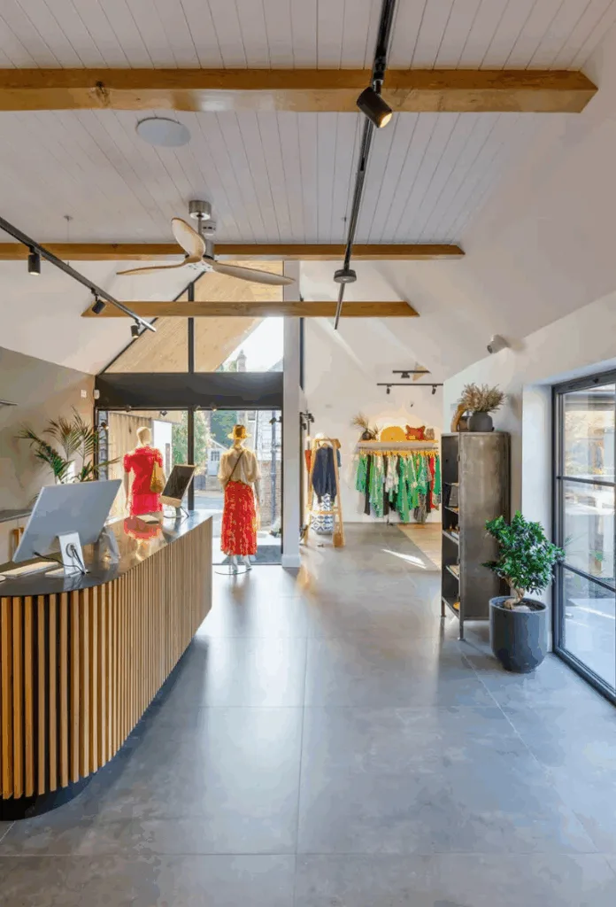Luxury retail interior with architectural surface finishes, natural light, timber detailing and polished flooring in a high-end commercial space